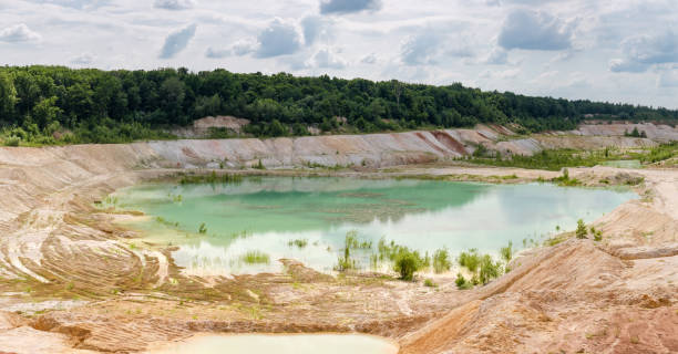 istock Small shallow turquoise quarry lake in abandoned kaolin pit, panorama 1334416944