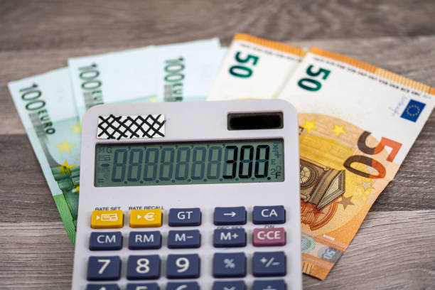 istock 50 100 euro banknotes with calculator 1334417287