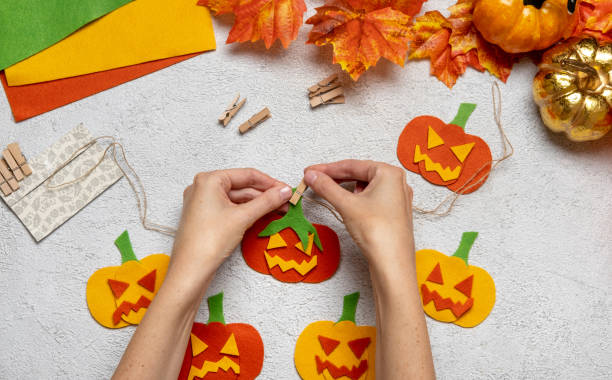 istock Step by step instruction: how to make a paper pumpkin  garland from colored cardboard or felt. Felt pumpkin for Halloween. 1334417296