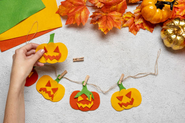 istock Step by step instruction: how to make a paper pumpkin  garland from colored cardboard or felt. Felt pumpkin for Halloween. 1334417837
