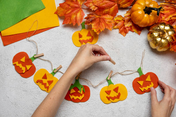 istock Step by step instruction: how to make a paper pumpkin  garland from colored cardboard or felt. Felt pumpkin for Halloween. 1334418357