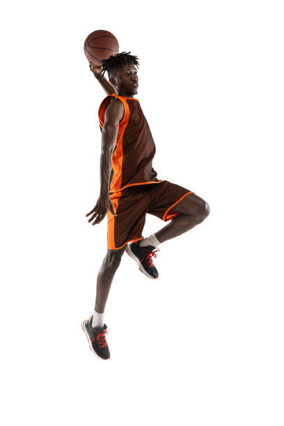 istock One young african man, basketball player training with ball isolated over white studio background. 1334418593