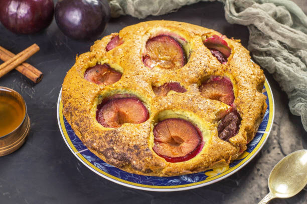 istock Traditional rustic plum cake on a dark background. 1334418926