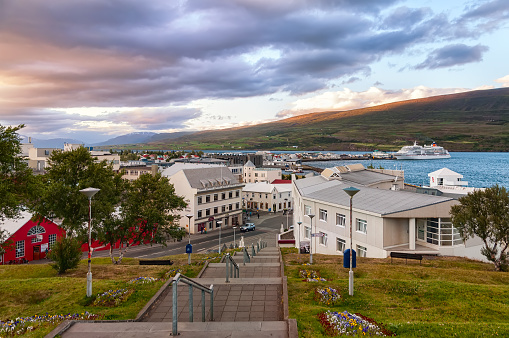 Akureyri, Iceland - August 8, 2012: Dramatic sky over Akureyri center at dusk. Akureyri, called the Capital of North Iceland, is an important port and fishing centre