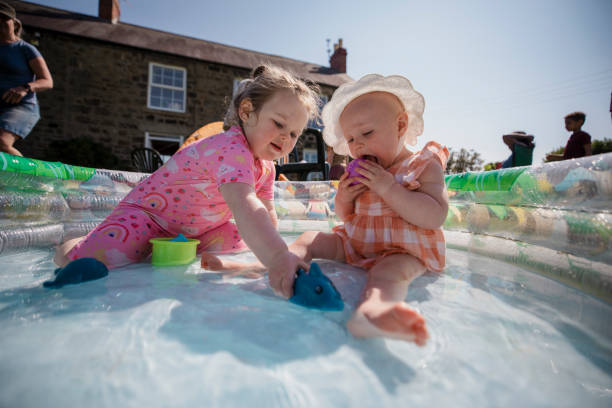 istock Girls in the Paddling Pool 1334423292