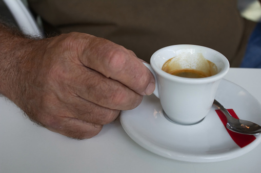 Man holding a cup with coffee