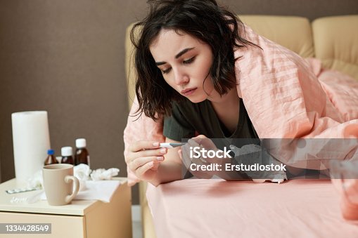 istock sick girl having influenza symptoms coughing at home 1334428549