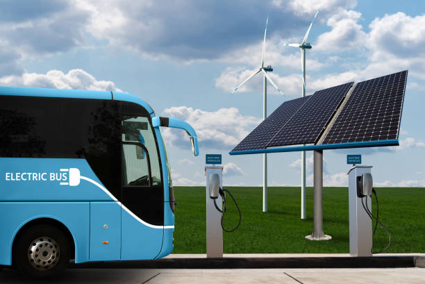 Electric bus with charging station stock photo