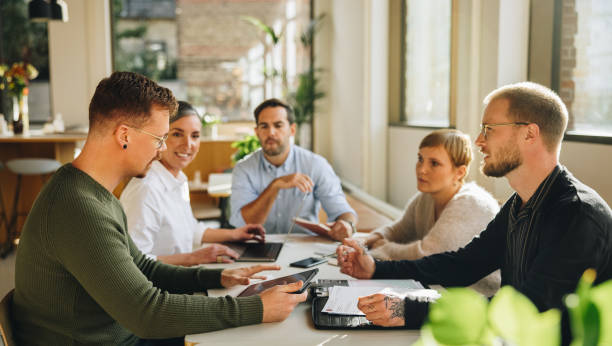 istock Businessman sharing new business plan with team 1334433126