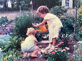 istock Big Sister Warning Little Brother 1988 in Garden 1334433318