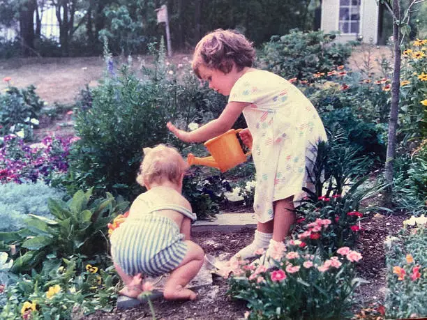 Cute brother and sister in garden 1988