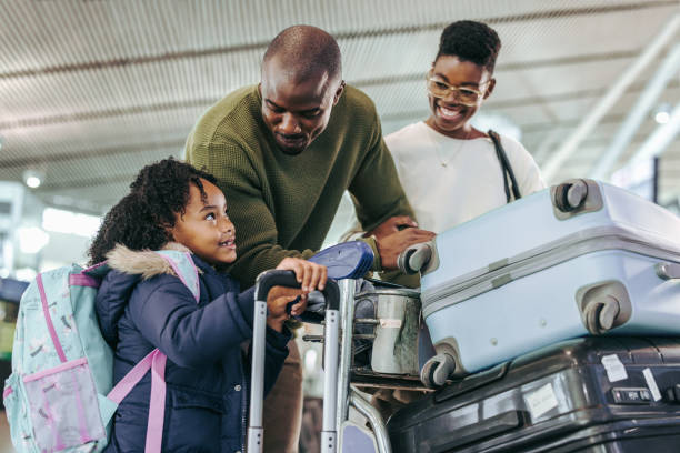 istock African kid talking with her parents at airport 1334434314