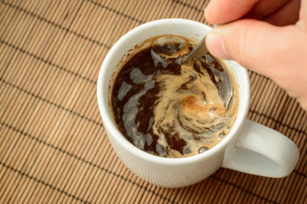 istock Man`s hand stirs coffee with a spoon. Making coffee in the morning 1334434467