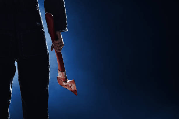 Serial killer with bloody axe stock photo
