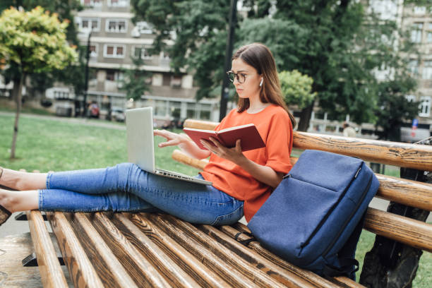 istock Girl enjoying studying in the park 1334435776