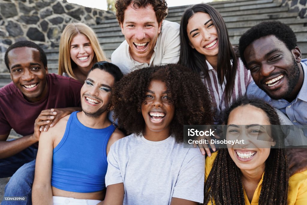 Young diverse people having fun outdoor laughing together - Diversity concept - Main focus on african girl face Community Stock Photo
