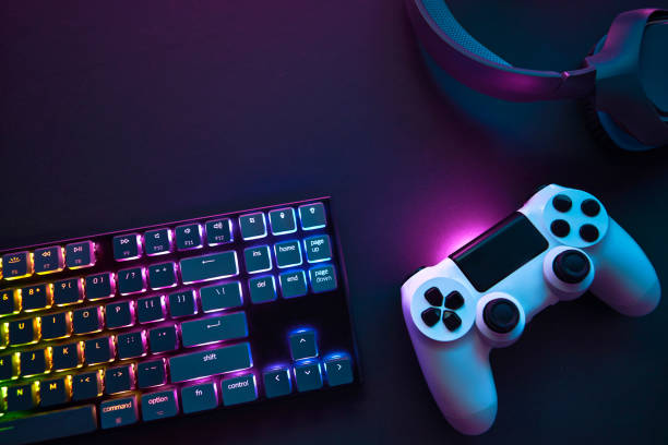 Top down view of colorful illuminated gaming accessories laying on table. Top down view of colorful illuminated gaming accessories laying on table. Professional computer game playing, esport business and online world concept. dependency photos stock pictures, royalty-free photos & images