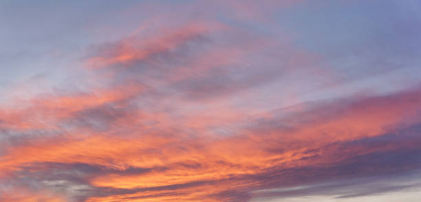 istock Pink orange sunset cirrus clouds on evening sky 1334436781