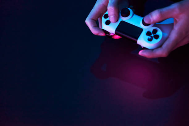 istock High angle view of male hands holding game controller. 1334436785