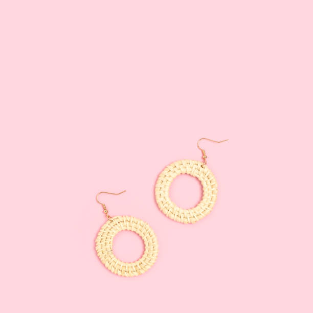 istock Wicker earrings on a pink pastel background. 1334436823