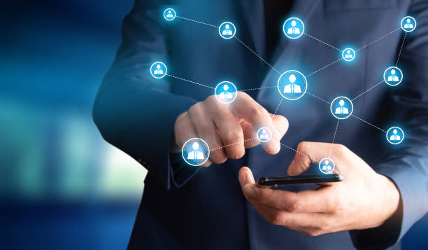 istock man holding phone with social network icon 1334437251