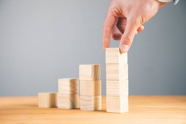 istock Hand holding blank wooden block cubes 1334437388