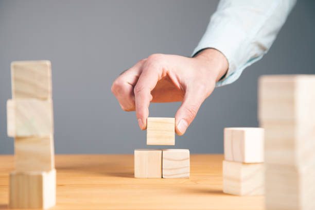 istock Hand holding blank wooden block cubes 1334437401