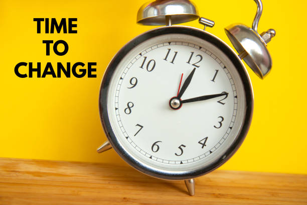 istock Retro alarm clock on bright yellow background 1334441048