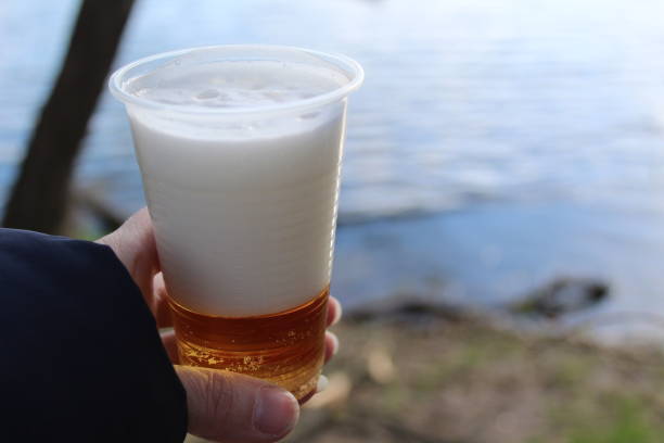 istock in the hand is a plastic cup with fresh beer on a picnic 1334442331