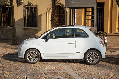 León, Spain - 11 August 2021: A side view of a Fiat 500 stationary in León, Spain