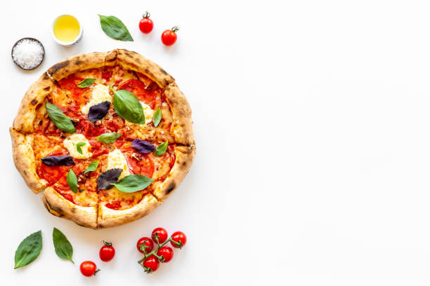 istock Food ingredients for cooking pizza - tomatoes cheese and basil 1334443669