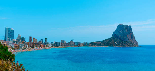 panoramic view of Calp, Valencian Community, Spain a view over Calp, in the Valencian Community, Spain, highlighting the apartment towers and the Penon de Ifac promontory on the right, in a panoramic format to use as web banner or header 3381 stock pictures, royalty-free photos & images