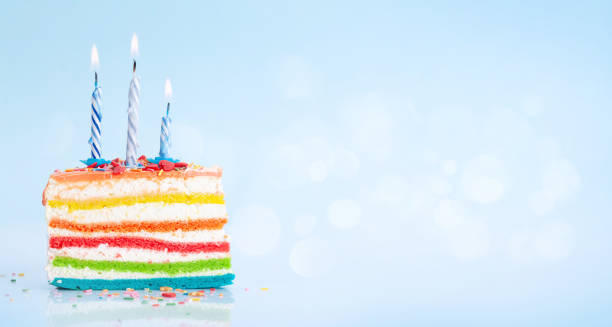 istock Birthday cake with burning candles on a blue 1334444779