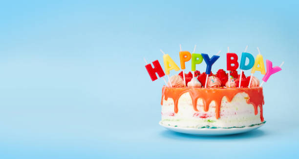 istock Birthday cake with candles on a blue 1334444817