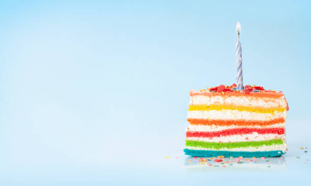 istock Birthday cake with candle on a blue 1334445401