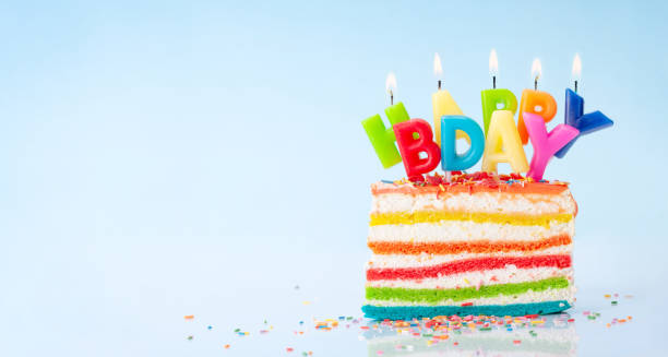 istock Birthday cake with burning candles on a blue 1334445421