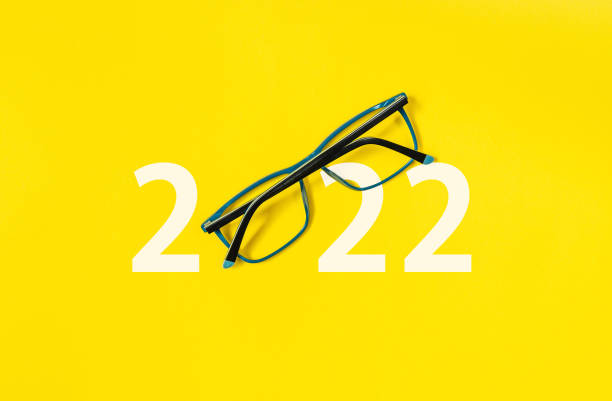 istock 2022 with glasses on yellow isolated background 1334445661