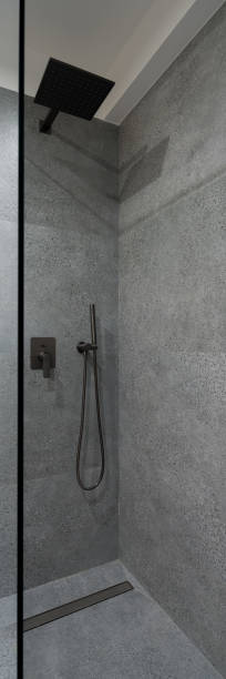istock Shower with glass wall and granite tiles, vertical panorama 1334446816