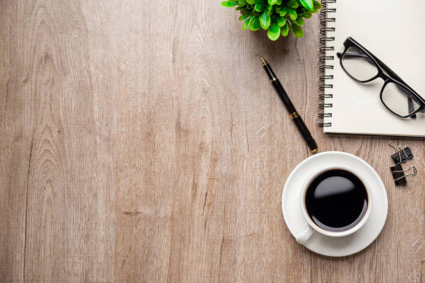 istock Flat lay, top view office table desk. Workspace with, laptop,office supplies, pencil, green leaf, and coffee cup on wood background. 1334448978