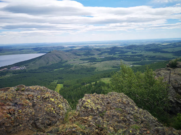 istock A large stone on the background of mountains with trees 1334449254