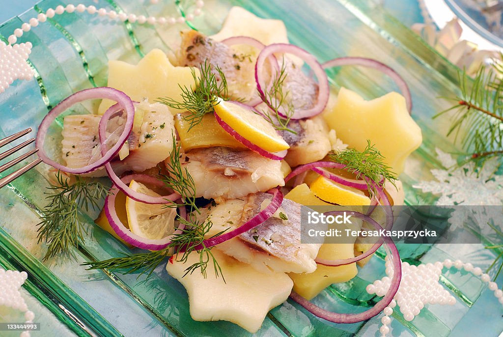 herring salad with potato and apple herring salad with potato and apple in star shape, gherkin,red onion and dill for christmas Herring Stock Photo