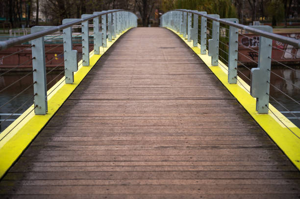 wooden bridge view in perspective in a rainy day, moody atmospheric photo