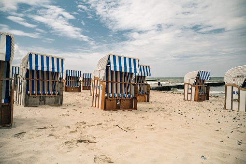 view on empty beach chairs at sand beach of the baltic sea