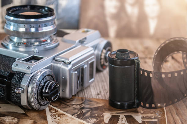 istock still life with retro analog camera, camera roll and old photos on wood background 1334456978