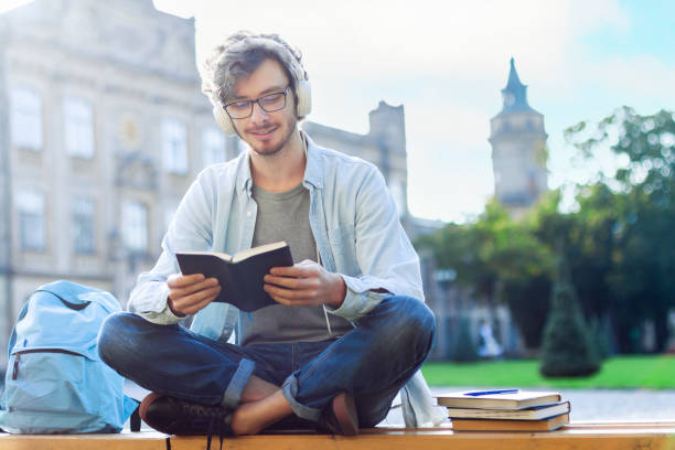 istock Student is reading book outdoor at campus. 1334461278