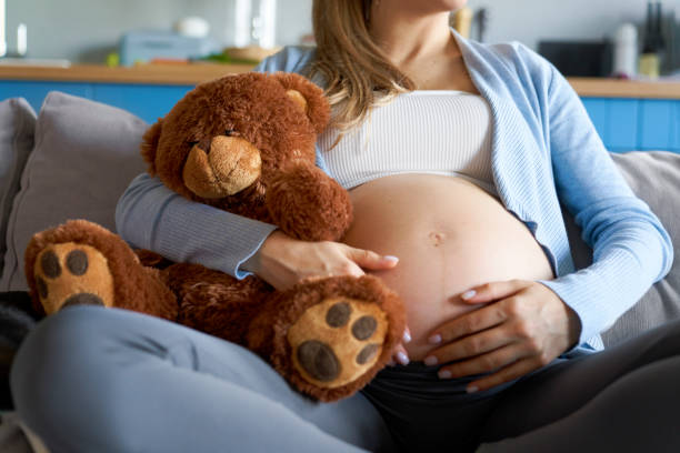 istock Pregnat woman with teady brear 1334462679