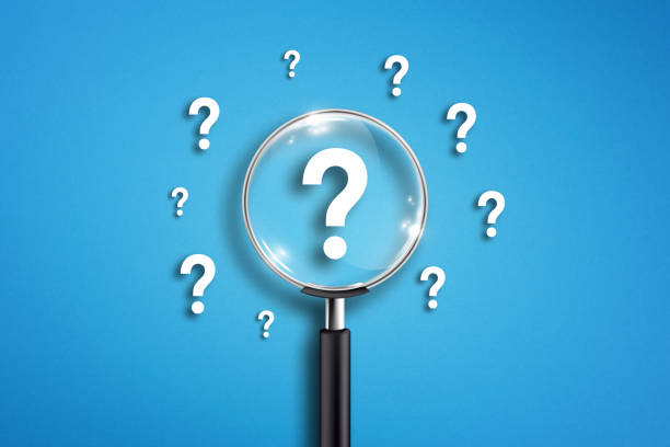 istock Magnifying glass and question mark on blue background 1334462790