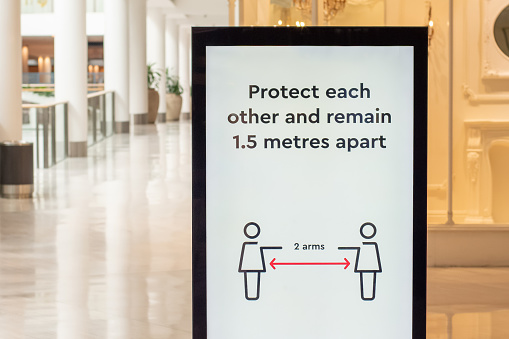 Social distancing information at the shoppint centre. Protect each other and remain 1.5 metres apart. Covid-19 outbreak
