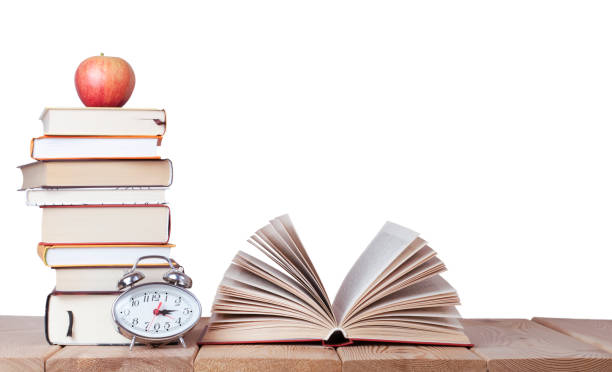 istock Education background with isolated books, red apple and alarm clock 1334467454