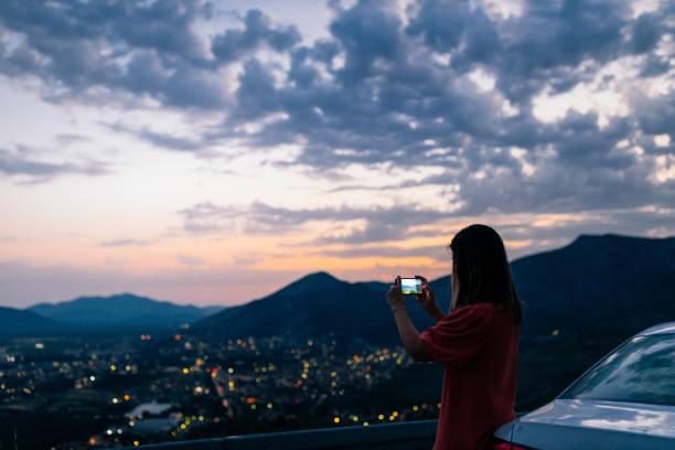 istock Young female traveler using mobile phone outdoors 1334467592